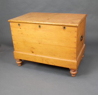 A Victorian pine chest fitted a drawer with secret compartment, the front fitted 3 locks and with iron drop handles to the sides, raised on bun feet 72cm x 94cm x 58cm 
