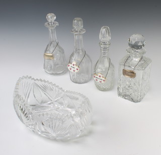 A cut glass boat shaped fruit bowl 27cm, 4 various decanters 2 with silver labels 