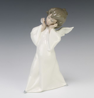 A Lladro figure of a standing angel 21cm 