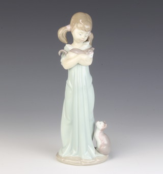 A Lladro figure of a girl holding a kitten with a cat at her feet 21cm 