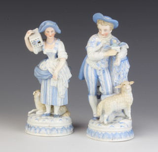A pair of late 19th Century German figures of a shepherd and shepherdess, the shepherd beside a tree trunk, the shepherdess holding a bird cage on her shoulder 19cm 