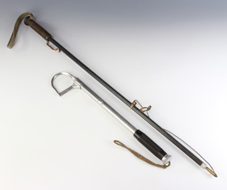 A vintage 3 draw salmon/pike fishing gaff together with a vintage salmon tail lifter, both marked Made in Great Britain 