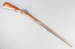 An 18th/19th Century percussion muzzle loader musket, the lock marked 1820 Tower and with 94cm barrel complete with ram rod, the top of the barrel marked with "Indian script", the stock is fitted a cap box  