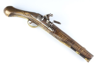 An 18th Century flintlock pistol with 22.5cm barrel and ram rod, having a carved walnut grip 
