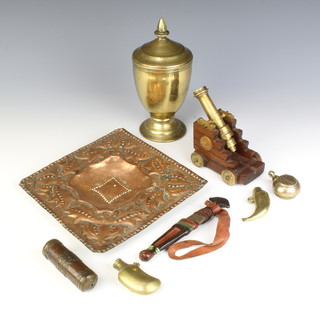 A gilt metal baluster shaped cup and cover on a spreading foot 20cm x 10cm, a square Newlyn style embossed copper dish 20cm x 20cm, a brass barrelled cannon 10cm raised on a trunion and other curios 