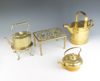 A Victorian oval brass 5 pint hot water carrier, a pierced brass footman, a circular brass kettle, a silver plated tea kettle and stand 