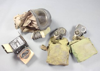 A WWII babies respirator, 2 ditto military issue service respirators and bags and a civilian respirator in original cardboard box and leather cloth case 