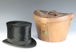 A light brown leather top hat box containing a black top hat by H W W Woodard, size 6 3/4 