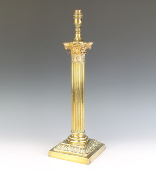 A gilt metal Corinthian column capital table lamp raised on a square stepped base 39cm x 15cm 