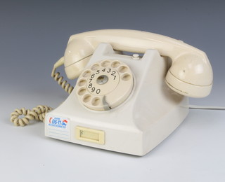 An Ericson ivory dial telephone marked PTT, the base marked MEI59 