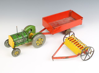A Mettoy tinplate model tractor (steering wheel missing), ditto grass rake (wheels bent) and a trailer 