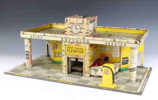 A Mettoy tinplate 2 tier garage with 1 petrol pump