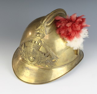 A Belgium brass fireman's helmet complete with plume 