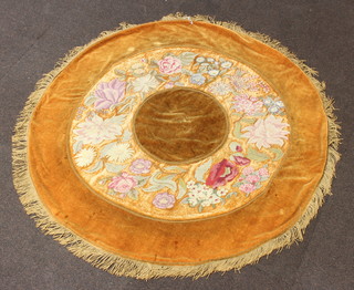 A circular chenille and wool work table cloth with deep beaded fringe 50cm diam. together with a red ground Persian style machine made tapestry panel 42cm x 66cm 