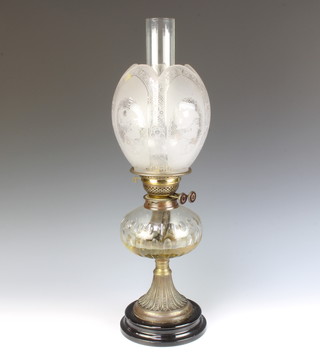 A Victorian faceted glass oil lamp reservoir with etched glass shade and clear glass chimney raised on a socle base 61cm x 15cm diam. 