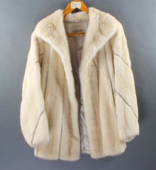 A lady's white three-quarter length fur jacket by Debers 