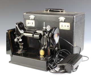 A Singer Featherweight 221 electric sewing machine complete with foot control, boxed