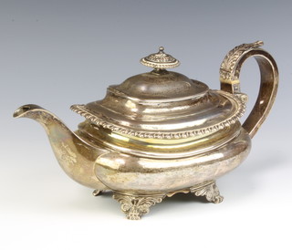A Georgian silver oblong teapot with gadrooned rim and C scroll handle, raised on scroll feet London 1789?, 790 grams gross
