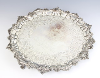 A George II silver salver with scroll rim and later presentation inscription, raised on pad feet London 1753, maker William Peaston, 32cm, 964 grams 