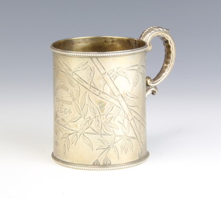 A Victorian silver mug with S scroll handle chased with birds amongst bamboo London 1883, 148 grams