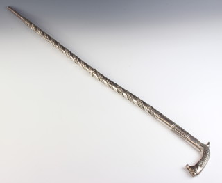 A Continental silver walking cane with animal handle and formal scrolling decoration 726 grams, 94cm