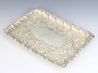 An Edwardian repousse rectangular silver dressing table tray with floral and scroll decoration 27cm x 20cm, maker George Nathan & Ridley Hayes, 310 grams