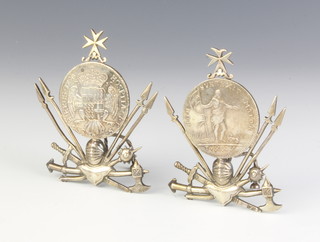 A pair of Maltese silver menu holds with military motifs mounted each with a Maltese coin 111 grams