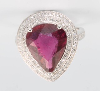 A 14ct white gold diamond and ruby ring, the pear cut ruby approx. 6.75ct surrounded by brilliant cut diamonds approx 0.65ct size N 