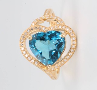 A 14ct yellow gold dress ring set with a heart cut blue topaz approx. 3.54ct, surrounded by brilliant cut diamonds approx. 0.35ct size M 1/2