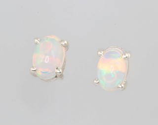 A pair of oval silver and opal ear studs, approx 1.2ct 
