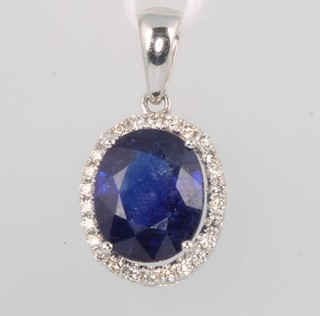 A white gold oval sapphire and diamond pendant 13mm x 11mm 