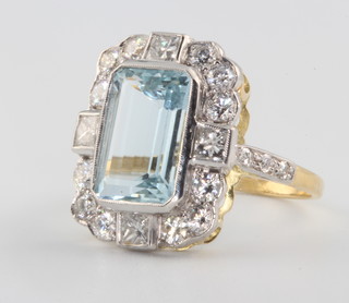 An 18ct yellow gold aquamarine and diamond ring the centre stone approx. 3.8ct surrounded by brilliant cut diamonds approx. 1.4ct size Q 