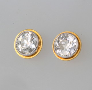 A pair of 18ct white and yellow gold single stone brilliant cut diamond ear studs, each approx 0.75ct 