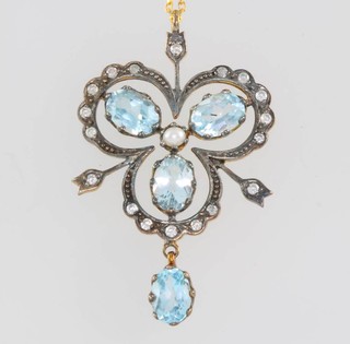 An Edwardian style yellow gold topaz and diamond open trifoil pendant on a 9ct chain 