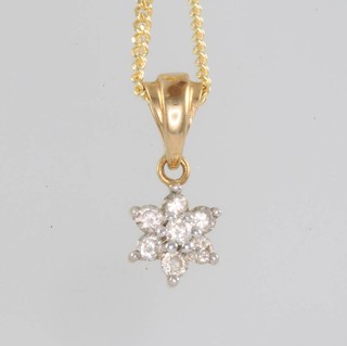 A 9ct yellow gold diamond set star pendant on a 9ct chain 50cm 