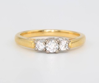 An 18ct yellow gold 3 stone diamond ring size N 