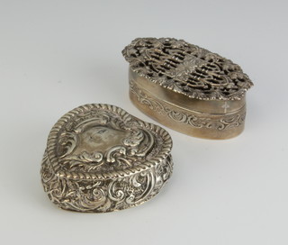A repousse silver heart shaped trinket box and an oval ditto 