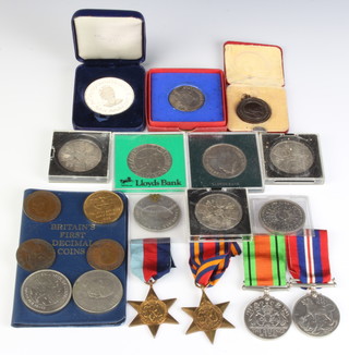 A World War Two group comprising 1939-45 Star, Burma Star, Defence medal and War medal and minor commemorative coins and crowns  