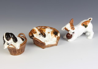 A Royal Doulton spaniel in a basket HN 2586, 8cm  a ditto HN 2585, 9.5cm and a terrier with ball, 10cm