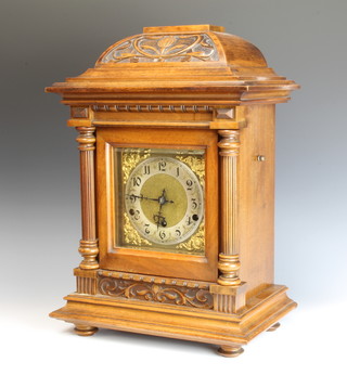 An Edwardian chiming bracket clock with square gilt dial and silver chapter ring contained in a carved walnut case 