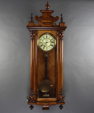 A Vienna style regulator with enamelled effect dial contained in a walnut case 
