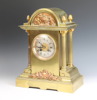 A French 19th Century 8 day striking mantel clock with silvered dial and Roman numerals contained in an arch shaped gilt metal case supported by columns 