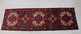 A red and blue ground Brojerd runner with 5 stylised medallions to the centre 312cm x 102cm 