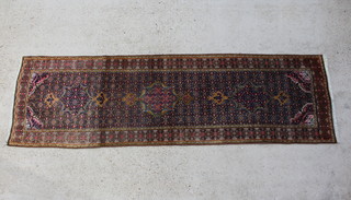 A tan, gold and terracotta ground Bidjar runner with 3 medallions to the centre 276cm x 81cm 