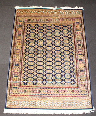 A blue and gold ground Bokhara style Belgium cotton rug with numerous octagons 230cm x 160cm  