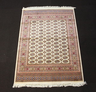 A white and gold ground Bokhara style Belgium cotton rug with numerous octagons to the centret 190cm x 140cm 