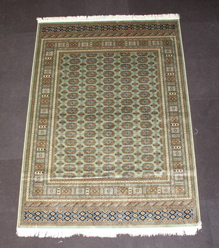 A green and gold ground Bokhara style Belgium cotton carpet with numerous octagons to the centre 230cm x 160cm 