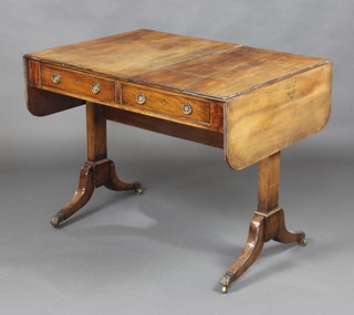 A 19th Century mahogany sofa table fitted 2 frieze drawers, raised on standard end supports, paw caps and castors 74cm x 95cm x 146cm when open 