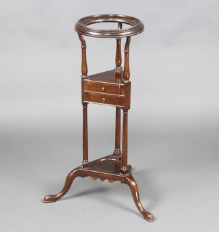 A circular Georgian style mahogany wash stand the upper section fitted a bowl receptacle with undertier fitted 2 long drawers, the base fitted a recess raised on cabriole supports 78cm h x 28cm diam. 