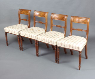 A set of 4 Georgian bleached mahogany and bar back dining chairs with shaped mid rails, over stuffed seats, raised on turned supports 
